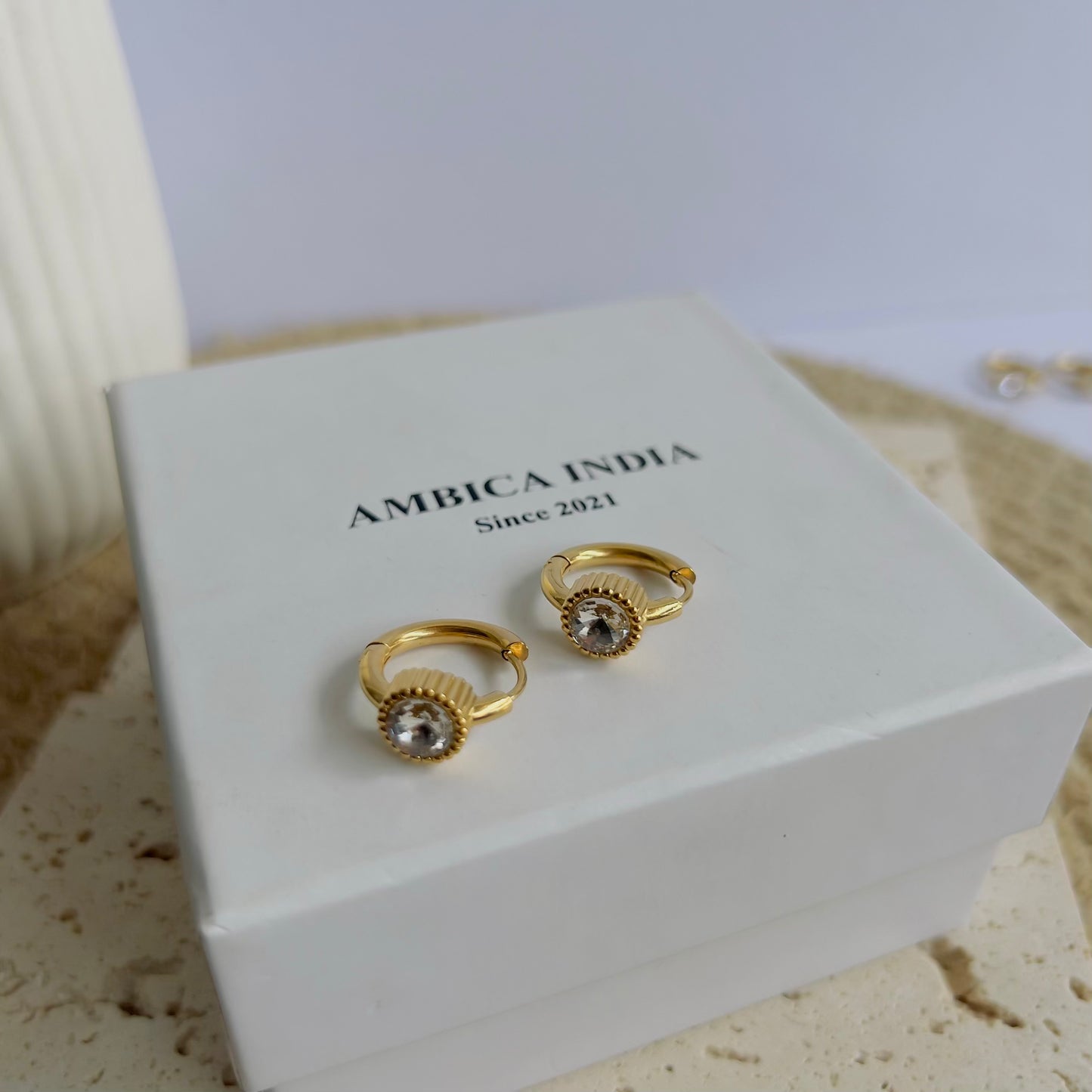 Round white crystal bezel huggie earrings
